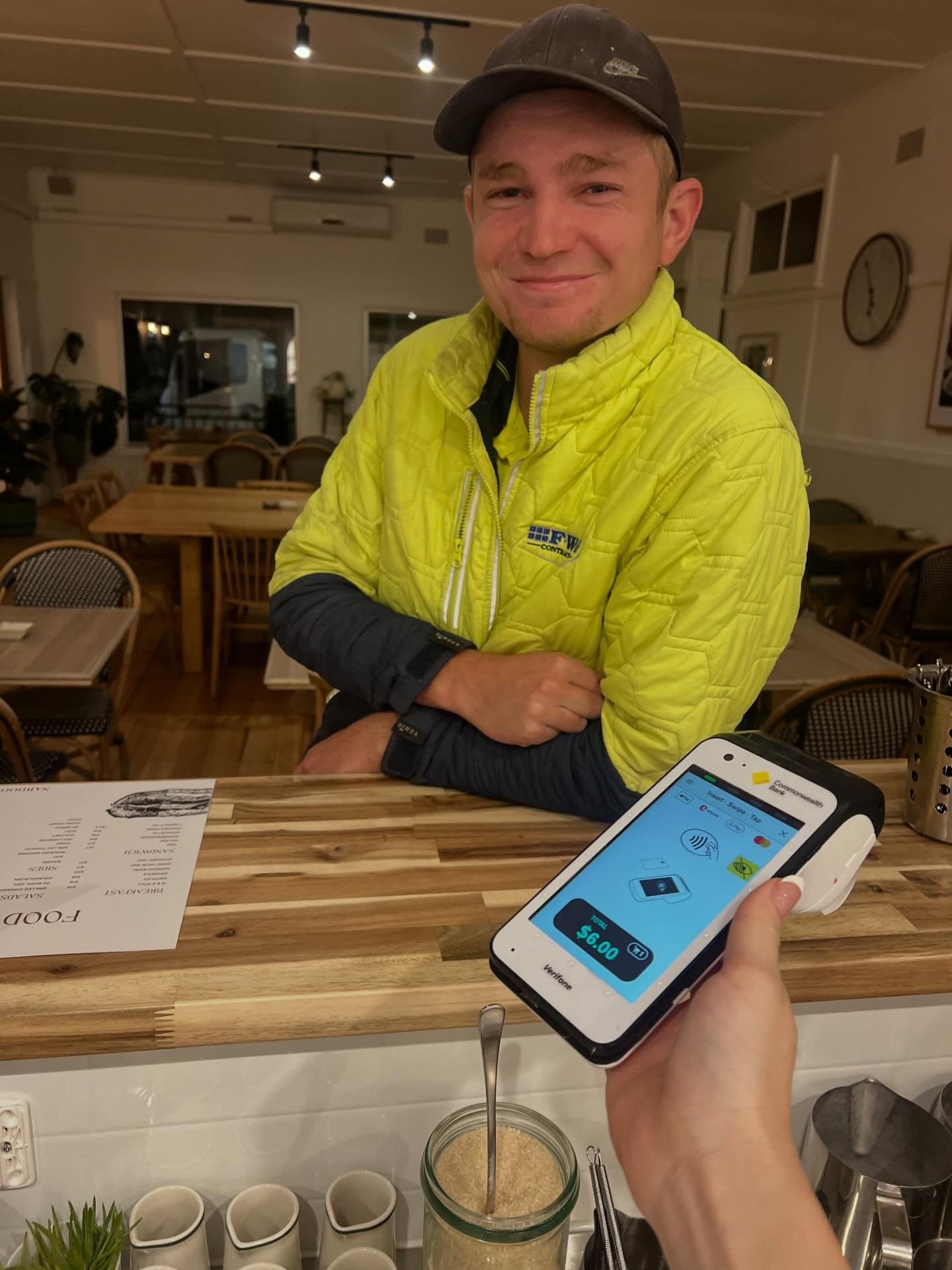 First customer on opening day paying at the counter